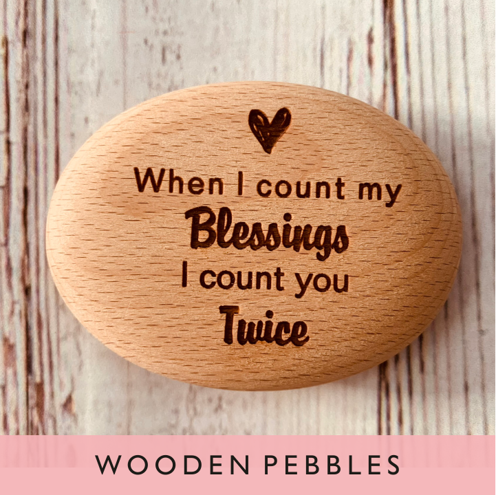 A selection of personalised wooden pebbles from GQGifts